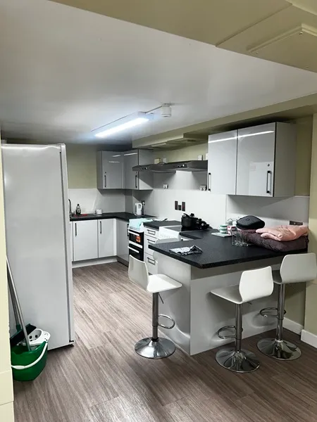 Walsall Kitchen with fridge, stools, worktops and cupboards