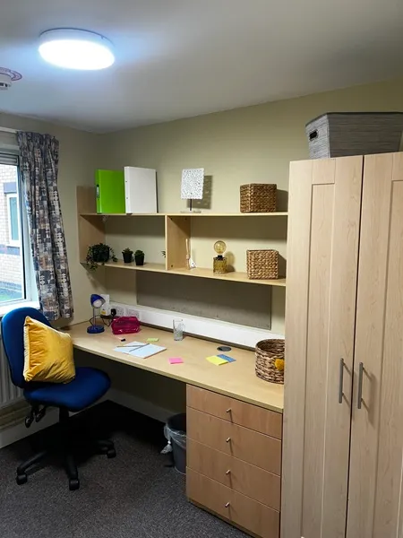 Ensuite room with chair, desk and wardrobe