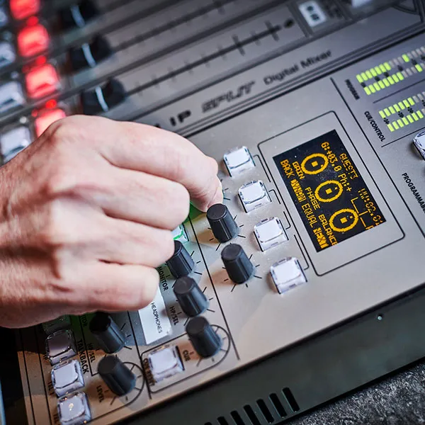 student using the control desk in the radio studio