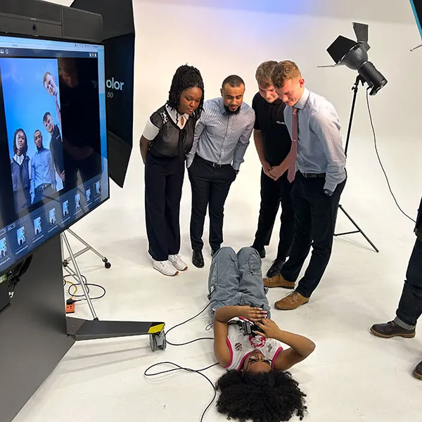 2 Photography students setting up a photoshoot in the large photography studio