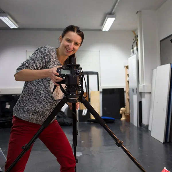 Photography student using a medium format camera on a tripod in the main photography studio