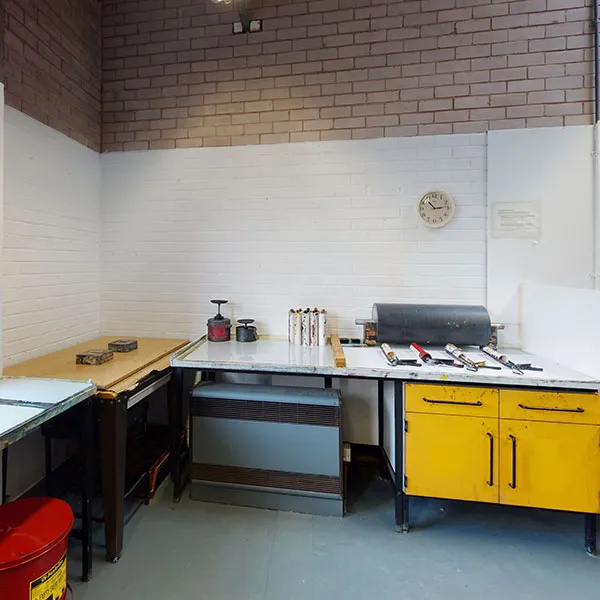 panorama of the Intaglio print room, showing the work surfaces, rollers and inks used in various intaglio print processes