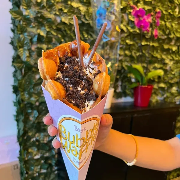 A bubble waffle from Boba Latto in Walsall, held in a paper cone reading THE BEST BUBBLE WAFFLE EVER