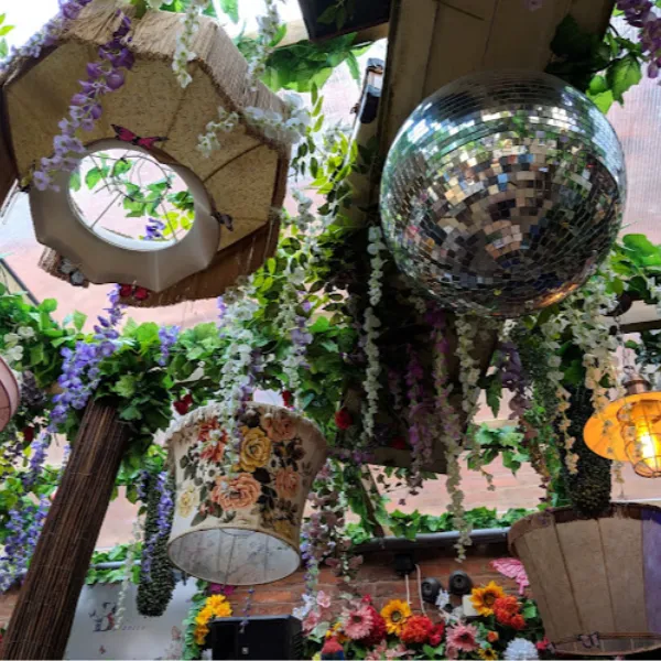 A disco ball, several light fittings and decorative plants on the ceiling of the Grain Store restaurant