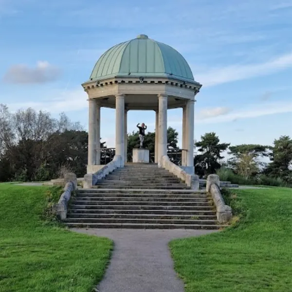 A pavilion in Barr Beacon: a staircase leading to a structure with six thin pillars and a round, sloping roof
