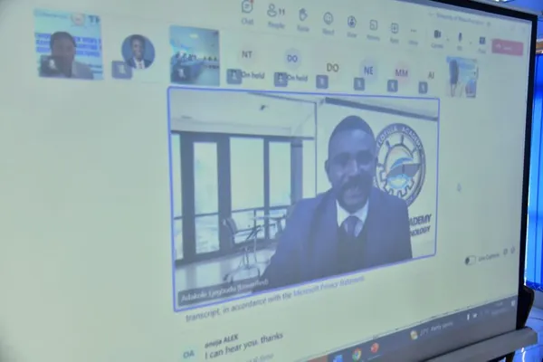 Photograph of a teams call where a speaker is addressing ten attendees.