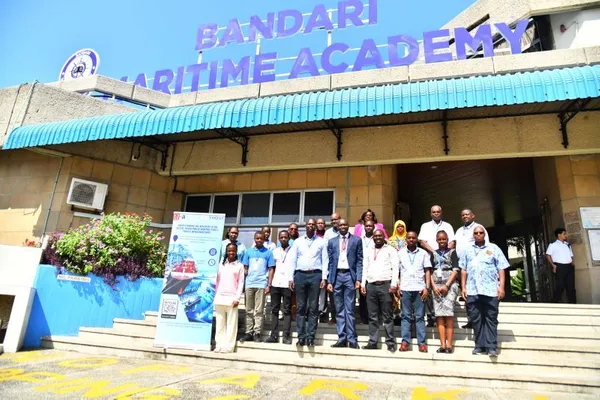 A group of people standing outside the Bandari Maritime Academy building.