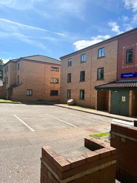 Exterior of Powys house building and another building like it, each three floors with windows on each floor.