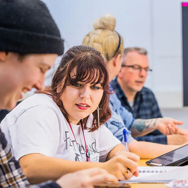 Illustration students engaged in conversation during a teaching session