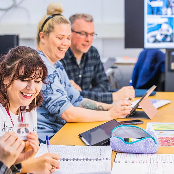 Illustration students engaged in conversation during a teaching session