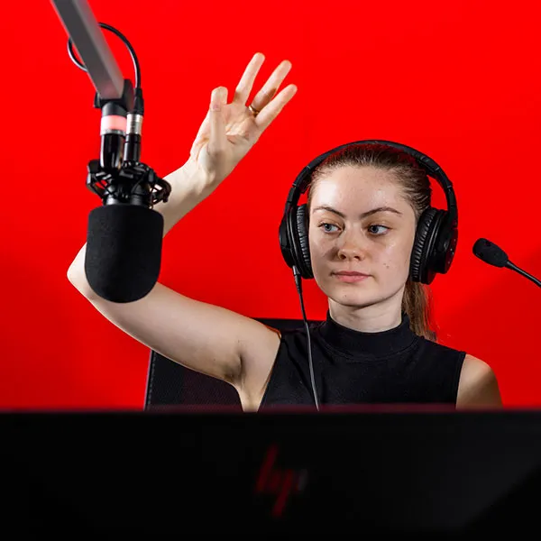 student recording in the radio studio