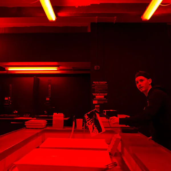 Photography student developing a black and white image in the photography darkroom.