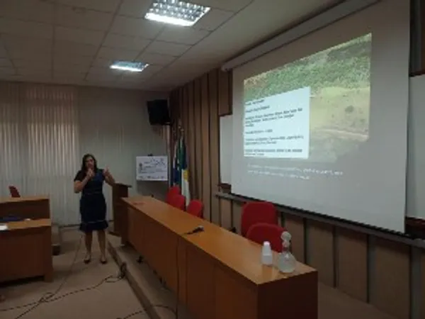 A DESIRE project lecture, the speaker gesturing towards an interactive whiteboard