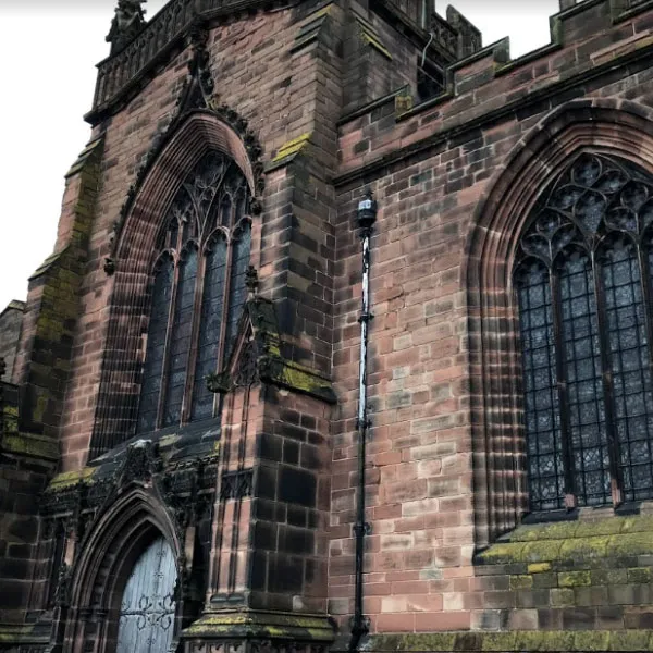 Exterior of St. Peters Church, with a large door and ornate arched windows