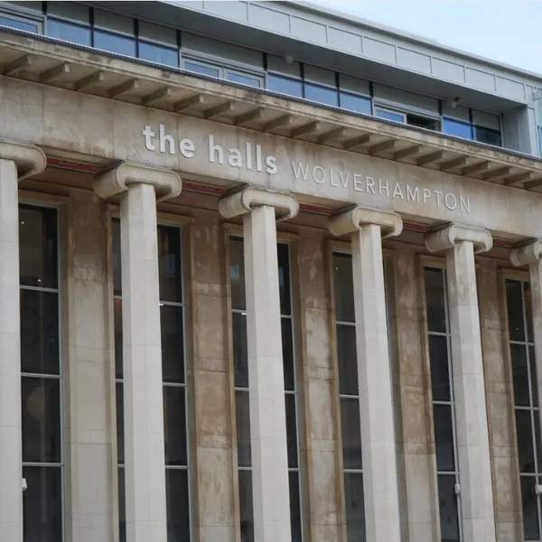 Exterior of the Halls building, with The Halls Wolverhampton signage above the entrance and a series of sculpted stone pillars