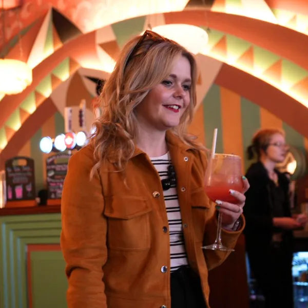 A person inside the Lupo Lounge café and bar holding a drink