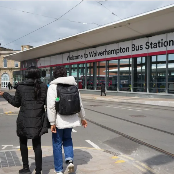 Two students walking outside the Wolverhampton Bus Station