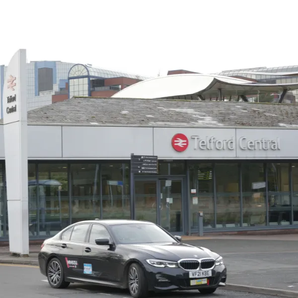 Telford Central train station with a taxi parked outside