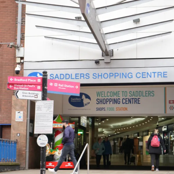 Outside Saddlers Shopping Centre in Walsall, with fingerpost signing pointing towards other key locations
