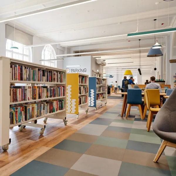 Rows of bookshelves in Walsall Central Library, to the left of seating areas